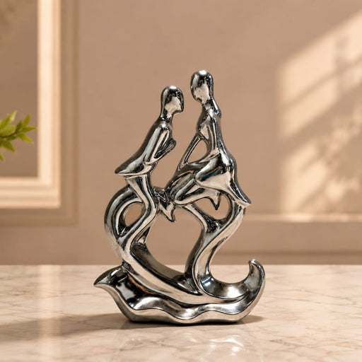 A close-up detail shot of the Silver Abstract Couple Figurine focusing on the artisanal carving and rich color.