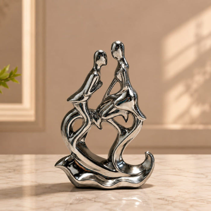 A close-up detail shot of the Silver Abstract Couple Figurine focusing on the artisanal carving and rich color.