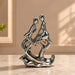 A close-up detail shot of the Silver Abstract Couple Figurine focusing on the artisanal carving and rich color.