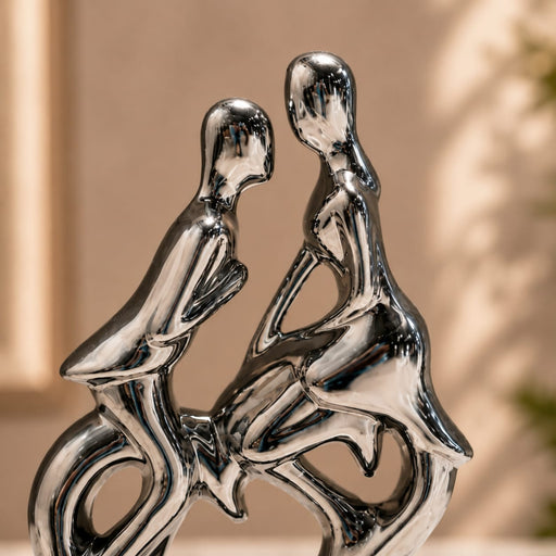 A direct front-facing view of the Silver Abstract Couple Figurine showcasing its vibrant details and premium finish.