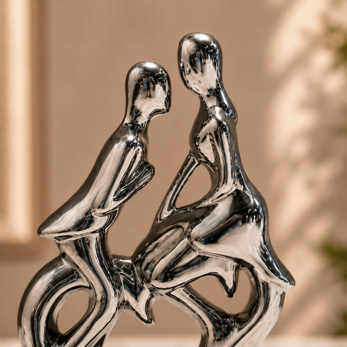 A direct front-facing view of the Silver Abstract Couple Figurine showcasing its vibrant details and premium finish.