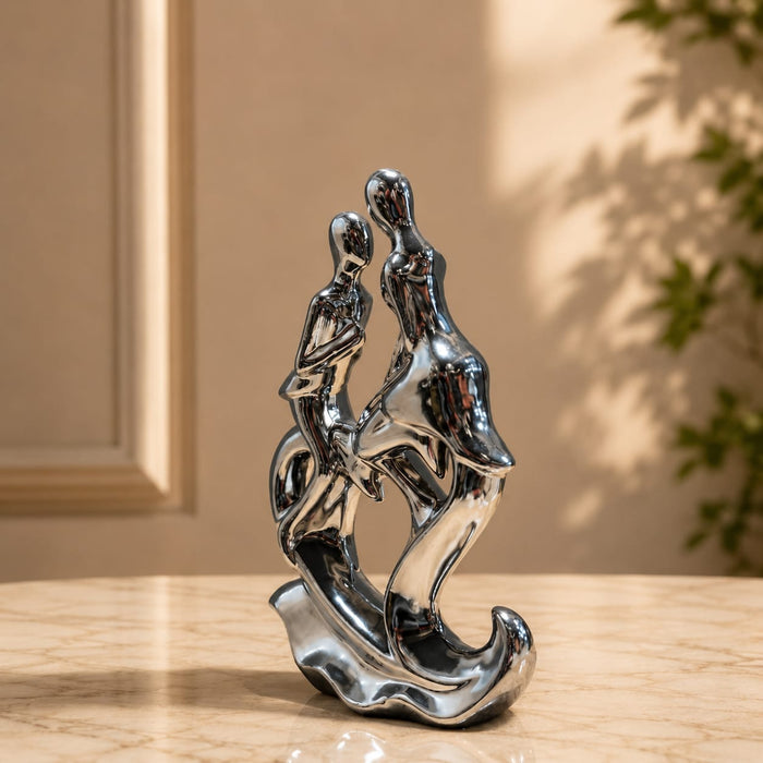 The Silver Abstract Couple Figurine beautifully styled in a modern home interior setting to inspire decor placement.