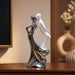 A close-up detail shot of the Silver Dancing Couple Figurine focusing on the artisanal carving and rich color.