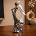 A side profile view of the Silver Dancing Couple Figurine revealing its graceful silhouette.