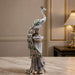 A close-up detail shot of the Silver Peacock on Pillar focusing on the artisanal carving and rich color.