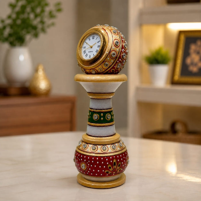 Detailed close-up of vintage analog clock dial, golden Roman numeral face, and embossed Kundan bead work