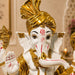 Side profile perspective showcasing elegant three-dimensional contours and sculptural depth of White and Gold Ganesha Resin Idol with Red Tilak (10.5 Inch)