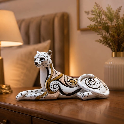 A close-up detail shot of the White and Gold Leopard Figurine focusing on the artisanal carving and rich color.