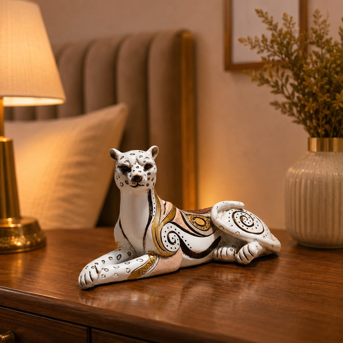 A side profile view of the White and Gold Leopard Figurine revealing its graceful silhouette.