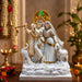 A close-up detail shot of the White and Gold Radha Krishna Idol focusing on the artisanal carving and rich color.