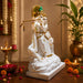 The White and Gold Radha Krishna Idol beautifully styled in a modern home interior setting to inspire decor placement.