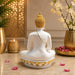 A close-up detail shot of the White Meditating Buddha Idol focusing on the artisanal carving and rich color.
