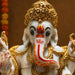 The White and Red Ganesha Idol beautifully styled in a modern home interior setting to inspire decor placement.