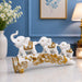 White Resin Elephant Family on Ornate Tusk Showpiece (13 Inch) - View 1