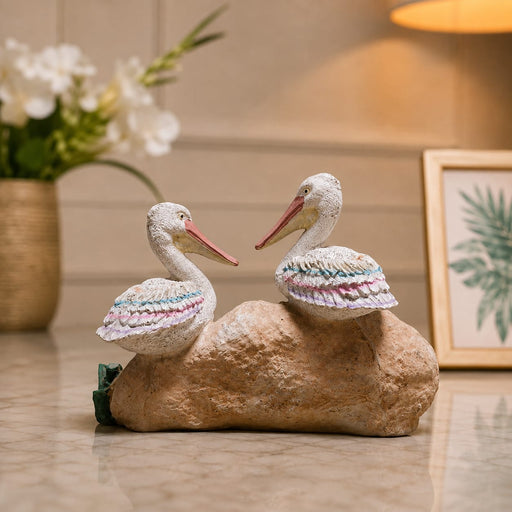 An angled perspective of the White Pelican Pair on Rock highlighting its elegant three-dimensional form and craftsmanship.