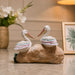 An angled perspective of the White Pelican Pair on Rock highlighting its elegant three-dimensional form and craftsmanship.
