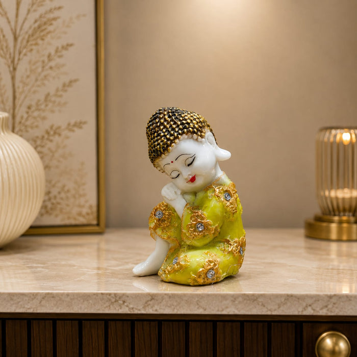 An angled perspective of the Yellow Little Buddha Figurine highlighting its elegant three-dimensional form and craftsmanship.